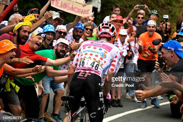 Neilson Powless of The United States and Team EF Education-EasyPost - Polka Dot Mountain Jersey competes in the breakaway while fans cheer during the...