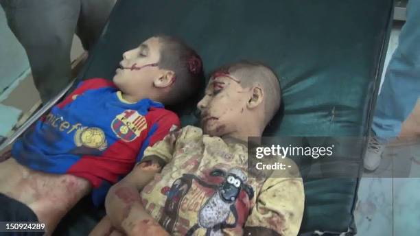 An image grab taken from a video uploaded on YouTube on July 21 shows the body of two boys following shelling by Syrian government forces in the...