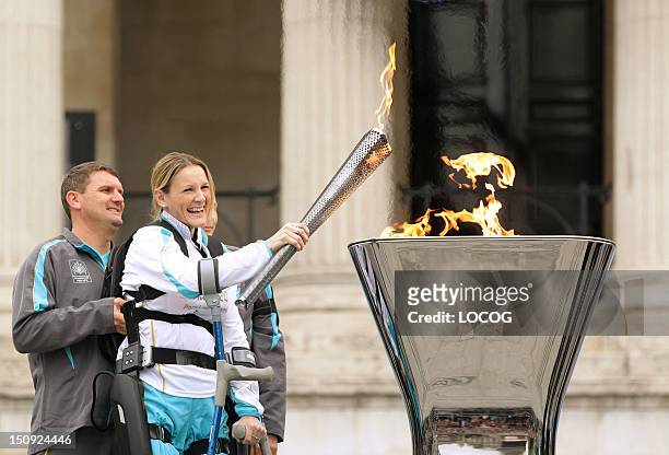 In this handout image provided by LOCOG, Claire Lomas lights the cauldron in Trafalgar Square, during the Paralympic Torch Relay, on August 24, 2012...
