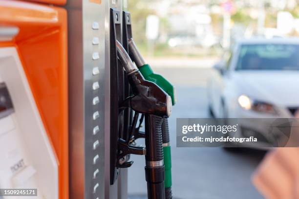 filling up the car tank at a gas station - fuel station stock pictures, royalty-free photos & images