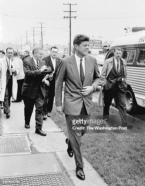 Followed by aides and newsmen, John F. Kennedy campaigns in Maryland ahead of the state's Democratic primary. Photographed May 12, 1960 in Silver...