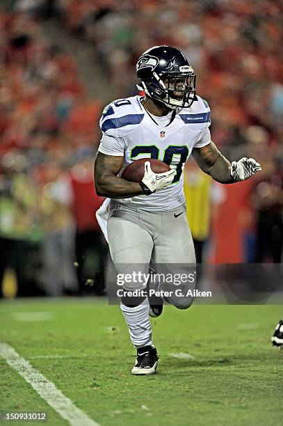 Running back Kregg Lumpkin of the Seattle Seahawks rushes to the outside against the Kansas City Chiefs during the second half of a preseason game on...