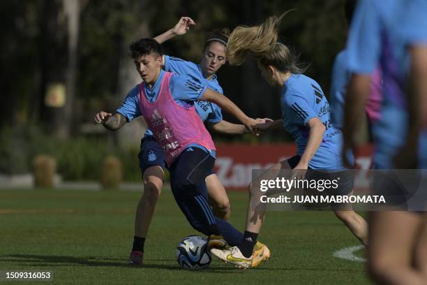 Argentina's midfielder Lorena Benitez fights for the ball with forward Mariana Larroquette and forward Camila Gomez Arias during a training session...