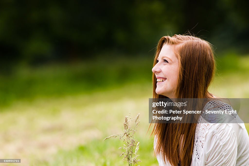 Young girl laughing in field