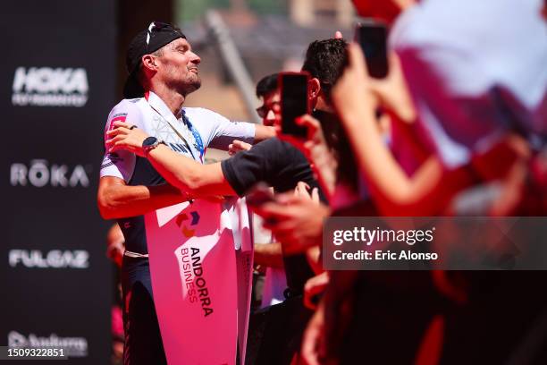 Jan Frodeno of Germany celebrates winning the men's IRONMAN 70.3 Andorra on July 02, 2023 in Andorra la Vella, Andorra.