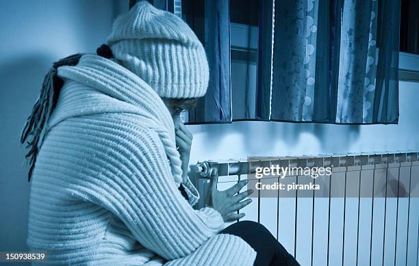 woman freezing at home - cold house stock pictures, royalty-free photos & images