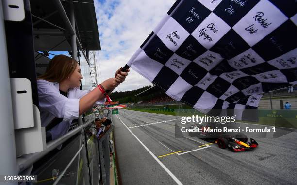 Race winner Max Verstappen of the Netherlands driving the Oracle Red Bull Racing RB19 takes the chequered flag during the F1 Grand Prix of Austria at...