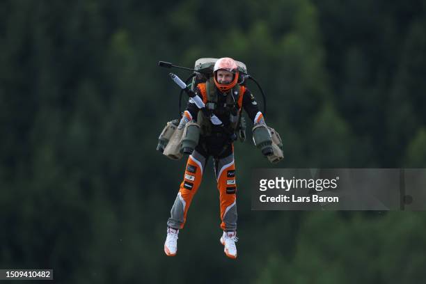 An entertainer wearing a jetpack flys over the circuit prior to the F1 Grand Prix of Austria at Red Bull Ring on July 02, 2023 in Spielberg, Austria.