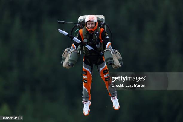 An entertainer wearing a jetpack flys over the circuit prior to the F1 Grand Prix of Austria at Red Bull Ring on July 02, 2023 in Spielberg, Austria.