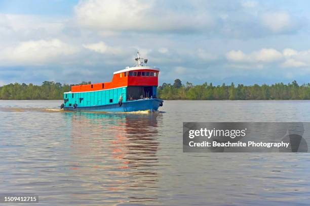 colourful cargo boat known as tongkang plying the rajang river in sibu, sarawak, malaysia - sibu river stock pictures, royalty-free photos & images