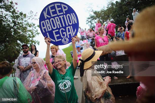 Protesters stand together during a Planned Parenthood rally as the Republican National Convention continues on August 29, 2012 in Tampa, Florida. The...