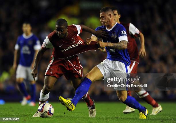 Ross Barkley of Everton in action with Kevin Lisbie of Leyton Orient during the Capital One Cup Second Round match between Everton and Leyton Orient...