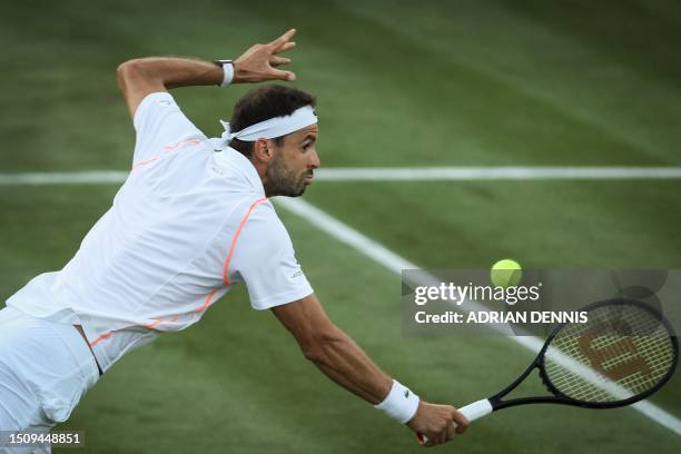 Bulgaria's Grigor Dimitrov dives to return the ball to Belarus' Ilya Ivashka during their men's singles tennis match on the fourth day of the 2023...