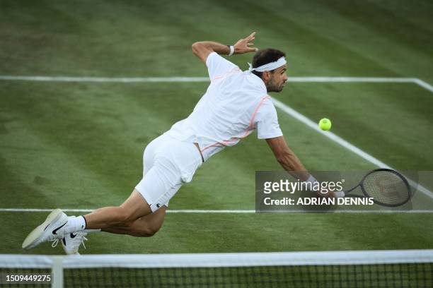 Bulgaria's Grigor Dimitrov dives to return the ball to Belarus' Ilya Ivashka during their men's singles tennis match on the fourth day of the 2023...