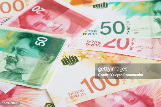 israeli shekel as a background - israel market stock pictures, royalty-free photos & images