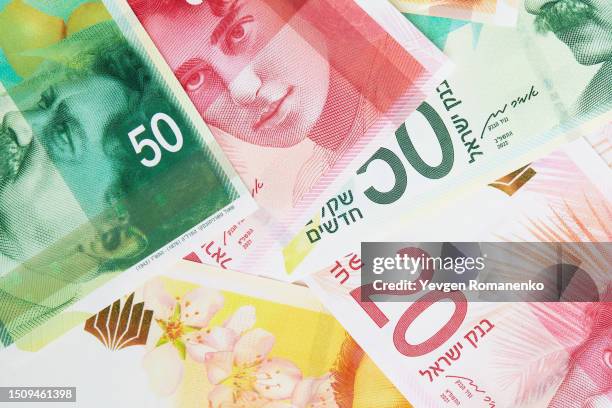 israeli shekel as a background - israel market stock pictures, royalty-free photos & images