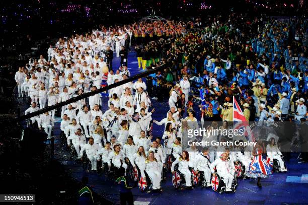 Wheelchair tennis player Peter Norfolk of Great Britain carries the flag during the Opening Ceremony of the London 2012 Paralympics at the Olympic...
