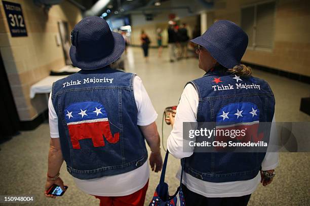 Pat Tippett of Baxley, GA and Linda Dennison of Blackshear, GA wear GOP logo cut-off jean jackets with matching blue hats during the third day of the...