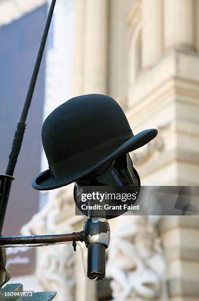 driver's hat resting on a horse carriage lamp - traditionally austrian stock pictures, royalty-free photos & images