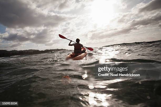 a man kayaks in the ocean - ocean kayak stock pictures, royalty-free photos & images