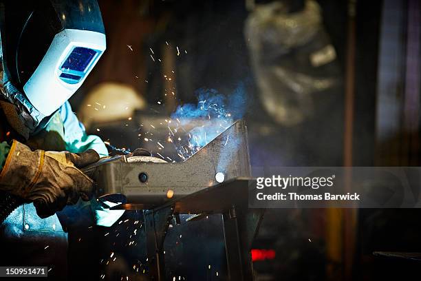 welder working in steel manufacturing facility - last day stockfoto's en -beelden