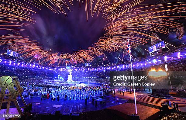 Fireworks light up the stadium as a large scale reproduction of Marc Quinns celebrated sculpture Alison Lapper Pregnant emerges during the Opening...