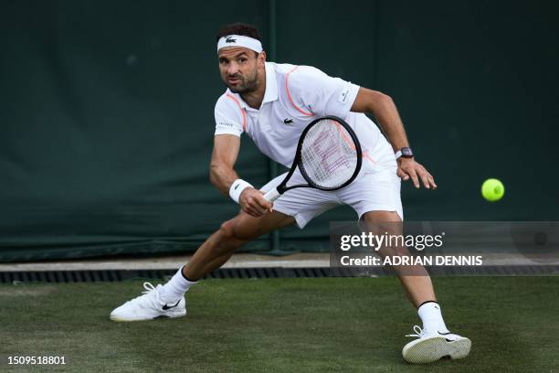 Bulgaria's Grigor Dimitrov returns the ball to Belarus' Ilya Ivashka during their men's singles tennis match on the fourth day of the 2023 Wimbledon...