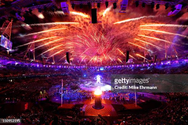 Fireworks light up the stadium as the Paralympic Cauldron burns during the Opening Ceremony of the London 2012 Paralympics at the Olympic Stadium on...