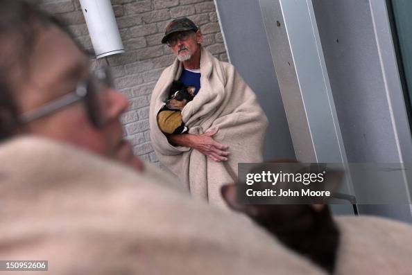 Mike Rasley Mike Easley and his wife Jinx Easley hold their dogs after being ...