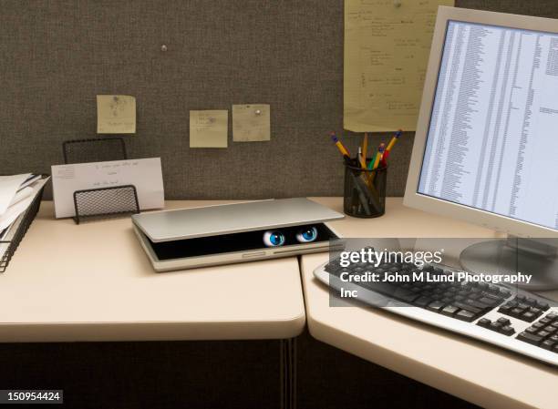 eyes peering from laptop on desk - ominous computer stock pictures, royalty-free photos & images