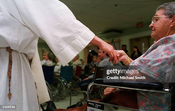 Year-old Carl J. Joseph, better known as WhatsYourName, extends his hand to a woman at the Mahoning Nursing Home in Jim Thorpe, Pa., March 29, 2000....