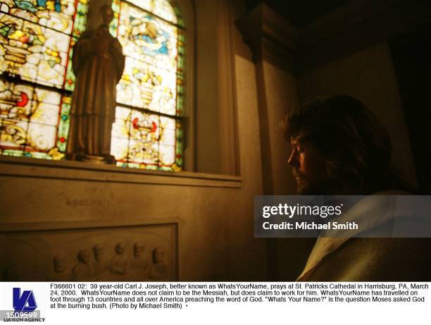 Year-old Carl J. Joseph, better known as WhatsYourName, prays at St. Patricks Cathedal in Harrisburg, PA, March 24, 2000. WhatsYourName does not...