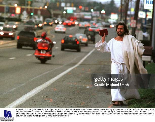 Year-old Carl J. Joseph, better known as WhatsYourName waves at cars in Harrisburg, PA, March 24, 2000. WhatsYourName does not claim to be the...