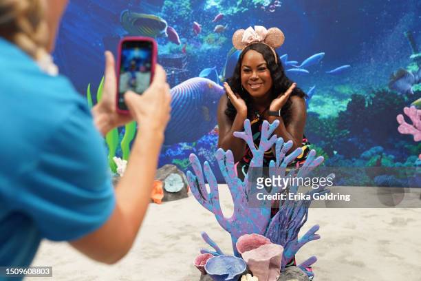 Guests pose for a photo at the Disney booth during the 2023 ESSENCE Festival Of Culture™ at Ernest N. Morial Convention Center on July 02, 2023 in...