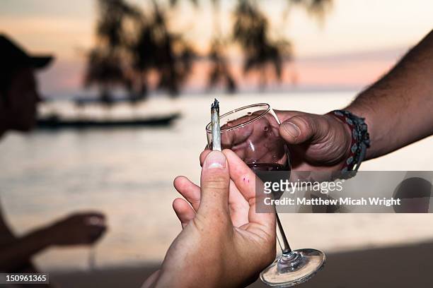 a couple of people pass a joint. - human joint stock-fotos und bilder