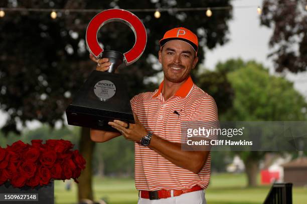 Rickie Fowler of the United States poses with the trophy after defeating Adam Hadwin of Canada and Collin Morikawa of the United States in a playoff...