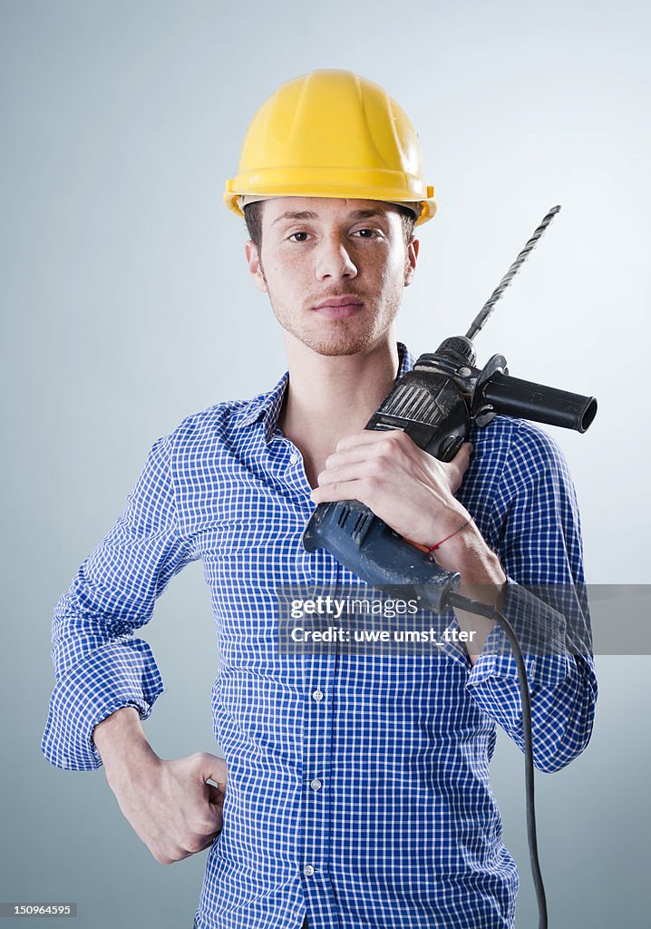 Portrait of a craftsman holding a drill