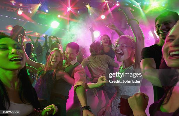 people dancing in a nightclub - clube noturno imagens e fotografias de stock