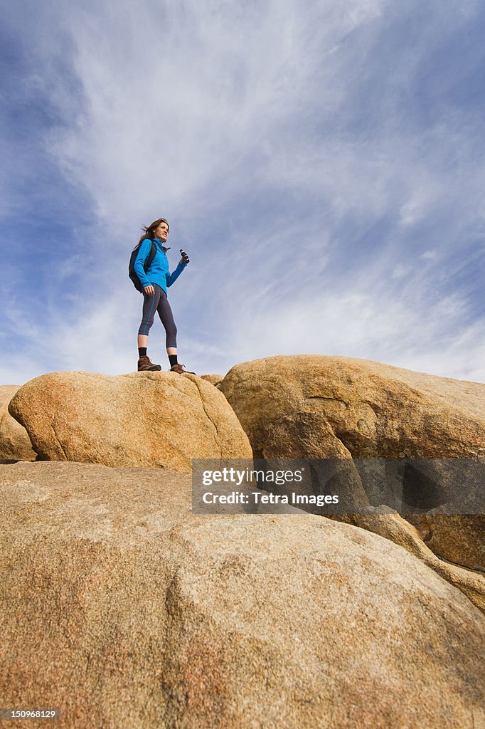 USA, California, Joshua Tree National Park, Female hiker on rocks