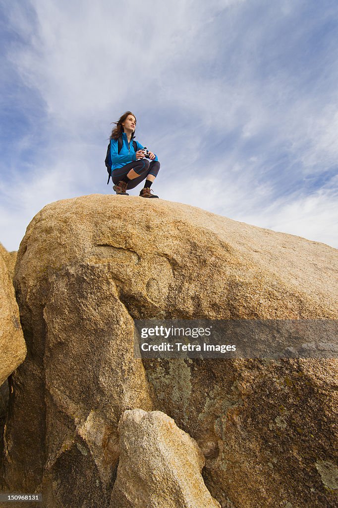 USA, California, Joshua Tree National Park, Female hiker on rocks