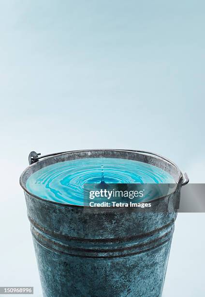 drop falling into water in bucket - bucket stock pictures, royalty-free photos & images