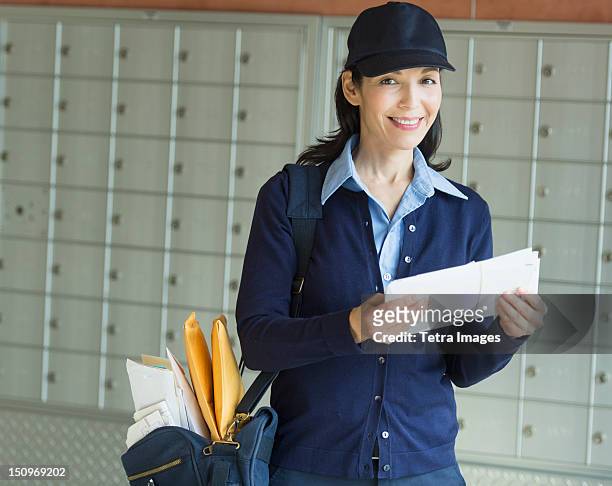 usa, new jersey, jersey city, female postal worker holding letter - postal worker stock pictures, royalty-free photos & images