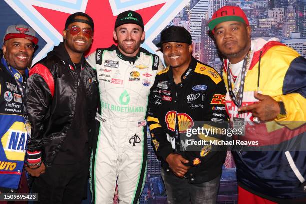 Lahmard Tate, Larenz Tate, Austin Dillon, driver of the Get Bioethanol Chevrolet, Larron Tate and Twista pose for photos at the drivers meeting in...