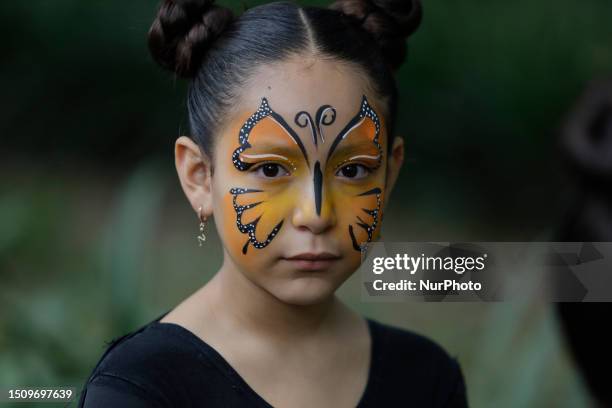 Girl with her face painted with the figure of a butterfly inside the Chapultepec Zoo in Mexico City, which celebrated a century of existence and held...