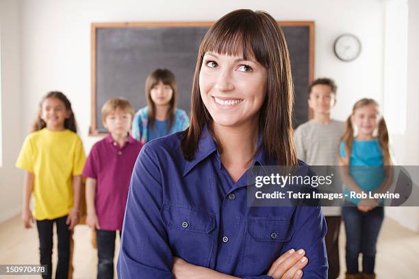 usa, california, los angeles, teacher with group of pupils in front of blackboard - tetra images teacher stock pictures, royalty-free photos & images