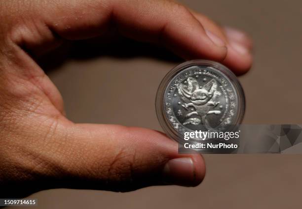 View of a commemorative coin of the Chapultepec Zoo in Mexico City, which celebrated a century of existence where dozens of people dressed up as...