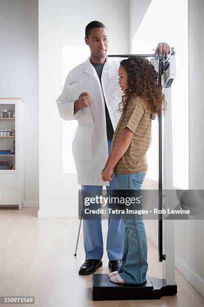 usa, california, los angeles, girl (8-9) at doctor's office - height stock pictures, royalty-free photos & images