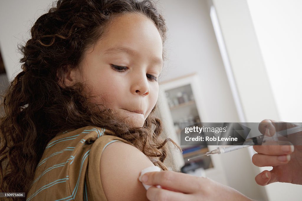 USA, California, Los Angeles, Girl (8-9) having vaccination