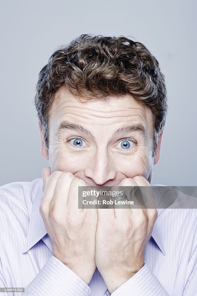 Portrait of worried mid adult man, studio shot