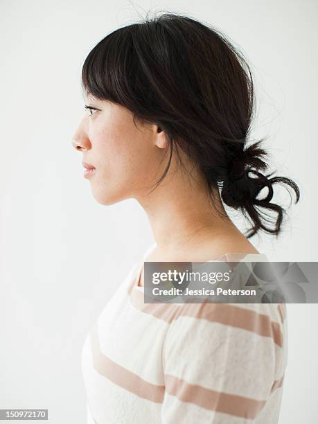 side view of young woman, studio shot - side face stock pictures, royalty-free photos & images